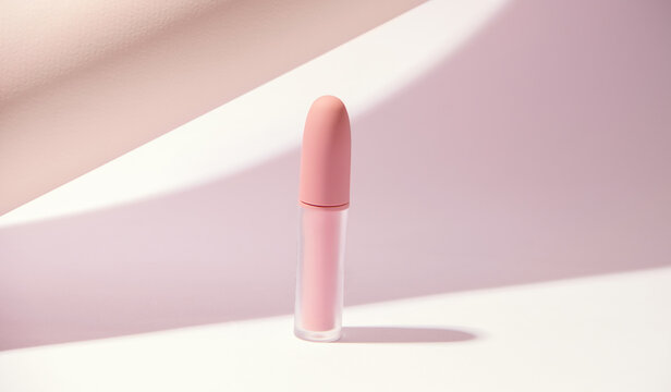 Makeup concept. Pink lipstick on a light background. Modern style