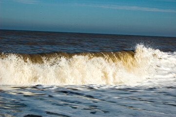 Dramatic Waves breaking on the shore. UK Norfolk coastline.