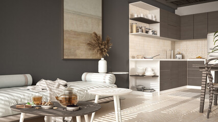 Cosy wooden sustainable kitchen and living room in dark tones with modern sofa and coffee tables. Tea time, glass teapot and teacup, snacks. Environmental friendly interior design