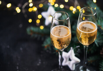 Two glasses of champagne on the holiday table with copy space
