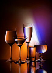 
Five glass goblets on a colored gradient background