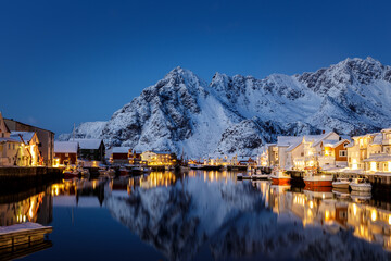 Blue Hour and the warm lights of the houses and boats in Norway