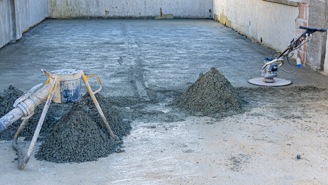 Employee performs sand and cement screed floor. Sand and cement floor screed