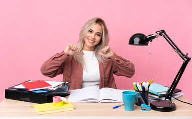 Young student woman working in a table proud and self-satisfied