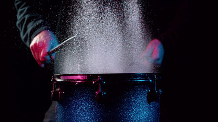 Freeze motion of drummer hitting drum with water splashes © Jag_cz