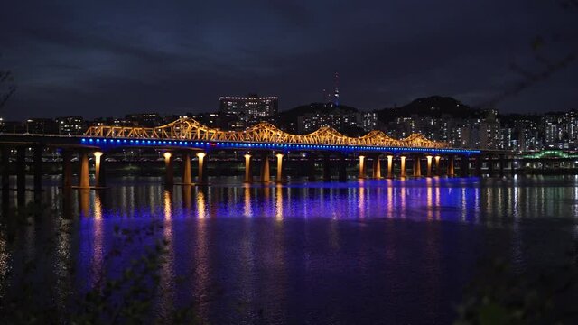Illuminated Dongho Bridge With High-rise Buildings In Background Spanning Han River At Night In Seoul, South Korea. - wide static shot