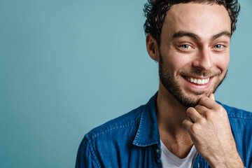 Happy handsome guy smiling and looking at camera