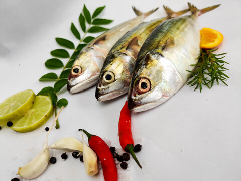 Close Up View Of Indian Mackerel Fish Decorated With Herbs. Isolated On White Background