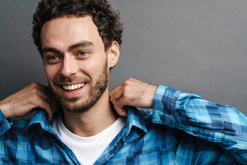 Fototapeta premium Joyful handsome guy smiling and posing on camera