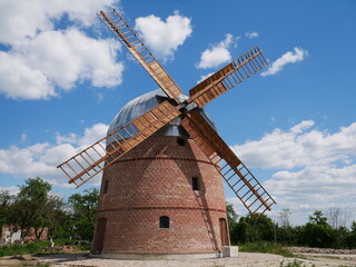 Fototapeta na wymiar Old wooden windmill in the field