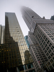 Canted shot of skyscrapers in New York City, Top of the building in the sky, Manhattan in the mist, Haze in the city, Autumn weather