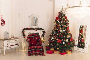 Christmas classic interior with christmas tree and a fireplace in traditional red color. Beautiful christmas decor. Happy new year concept.	