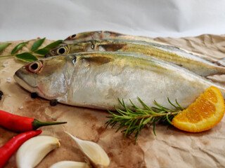 Close Up View Of Indian Mackerel Fish Decorated With Herbs.  Isolated On White Background.