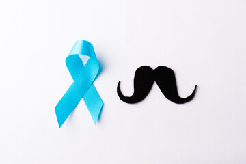 Black mustache paper and light blue ribbon, studio shot isolated on white background, Prostate...