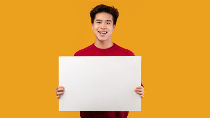 Asian guy holding blank white advertising board