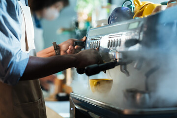 Barista make coffee with espresso machine in cafe and social distancing