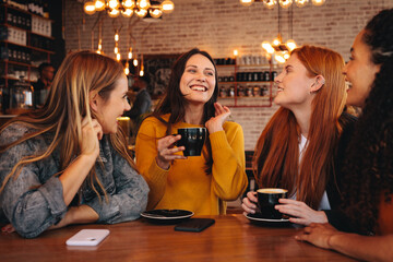 Happy young friends meeting in a coffee shop