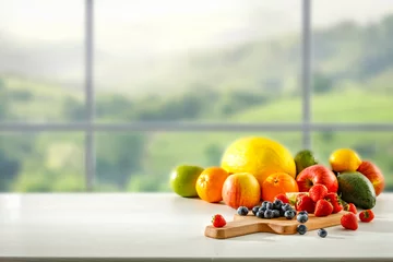 Fotobehang Fresh fruit in the kitchen on a wooden table by the sunny window © magdal3na
