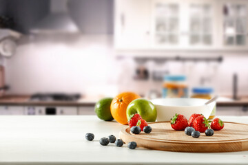 Fresh fruit in the kitchen on a wooden table by the sunny window