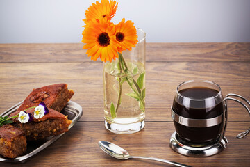 delicious oriental sweets with black coffee and flowers on the table