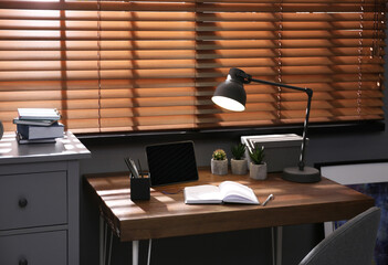 Stylish room interior with comfortable workplace near window