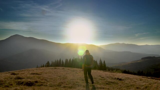 A man travels in the mountains. Beautiful nature of the Carpathian mountains. The concept of travel and active lifestyle. 4K