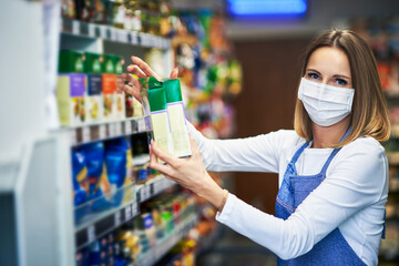 Shop assistant working in medical mask