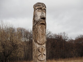 ancient wooden idol of the Slavic Scandinavian god against the sky