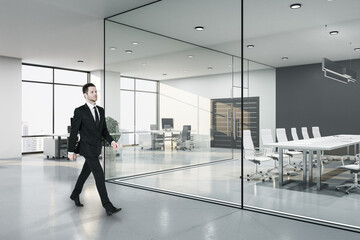 Fototapeta premium Businessman walking in contemporary meeting loft room