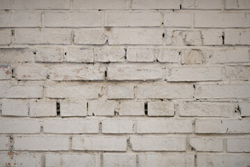 Unique texture of a brick wall painted with cream paint