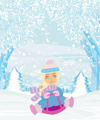 fun in the winter day - the girl is sledding