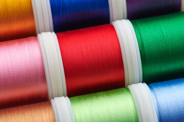 Background from spools with multicolored sewing threads