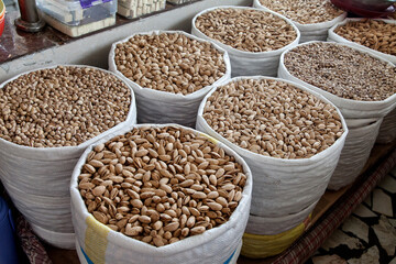 Fototapeta premium Various pistachio nuts, bodom are sold in bags at the Chorsu bazaar in Tashkent.