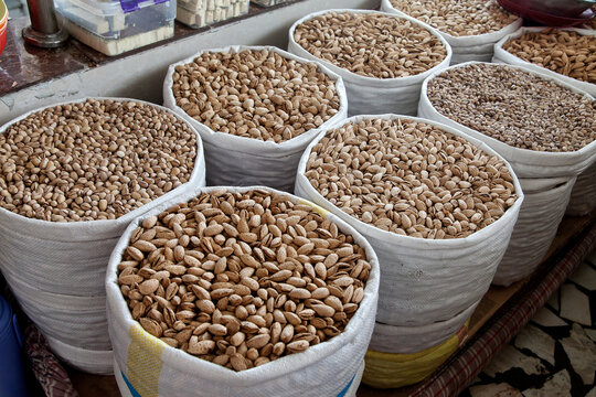 Various pistachio nuts, bodom are sold in bags at the Chorsu bazaar in Tashkent.