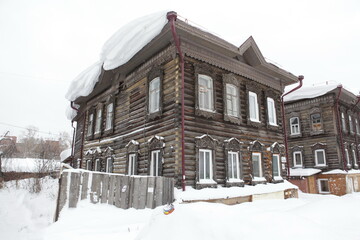 Vintage wooden house with carved windows in Tatarskaya Street, 42, Tomsk city, Russia. Russian...