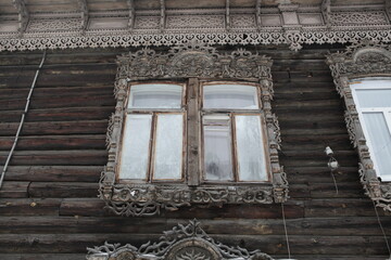 Window with carved frame of old wooden house in Tatarskaya Street, 42, Tomsk city, Russia. Russian...