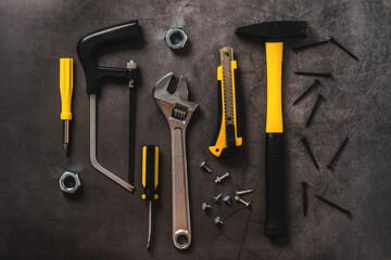 Various yellow repair tools, equipment for building. Grey background top view 