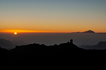 Sunset with the rock Roque Nublo and the Teide volcano in the background, Gran Canaria, Canary Islands, Spain