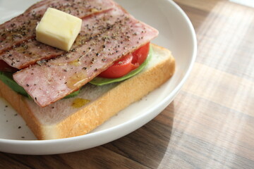 パンとバターとトマトとアボカドをのせた白いお皿