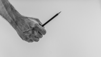 A man holding a black pencil on a white background.