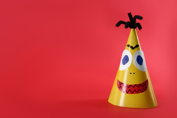 Funny yellow monster on red background, space for text. Halloween decoration