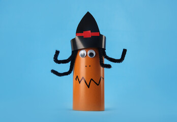 Funny orange monster on light blue background. Halloween decoration