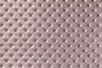 Fototapeta premium Texture of light brown leather background with capitone pattern, macro.