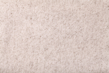 Light beige fluffy background of soft, fleecy cloth. Texture of cream textile.