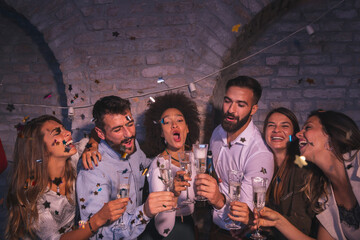 Friends making a toast for New Year's Eve midnight countdown