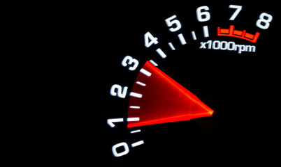 Close up shot of a tachometer in car. Car dashboard. Dashboard details with indication lamps.Car instrument panel. Dashboard with tachometer isolated on black.