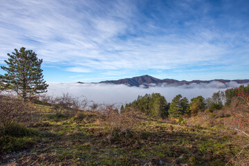 Autumn mountain landscape with low clouds, province of Genoa, Ligurian Alps, Italy.
