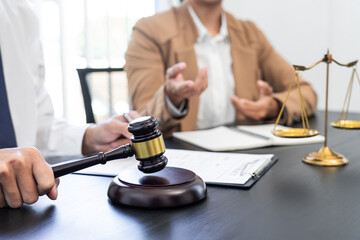 lawyer or judge meeting with client consulting help discussing contract paper agreement.