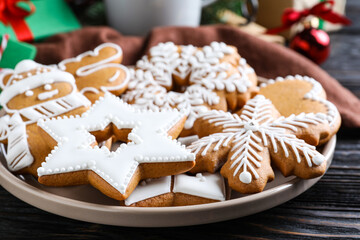 Delicious Christmas cookies on black wooden table table, closeup
