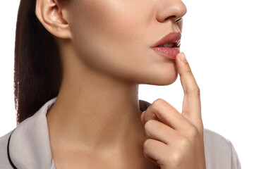 Fototapeta na wymiar Woman with herpes touching lips on white background, closeup